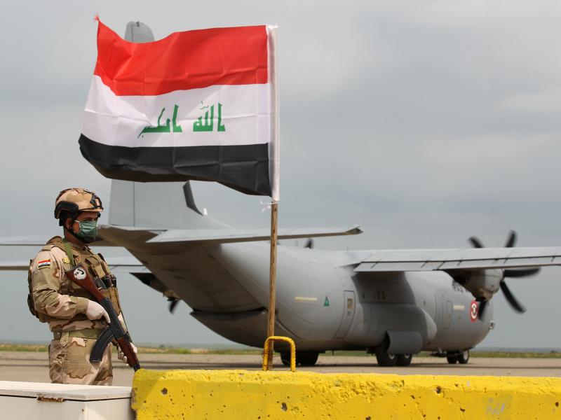 An Iraqi soldier stands guard near a U.S. military air carrier at the Qayyarah Airfield West, before the U.S. transferred the base to Iraqi forces in March. An Iraqi soldier stands guard near a U.S. military air carrier at the Qayyarah Airfield West, before the U.S. transferred the base to Iraqi forces in March.