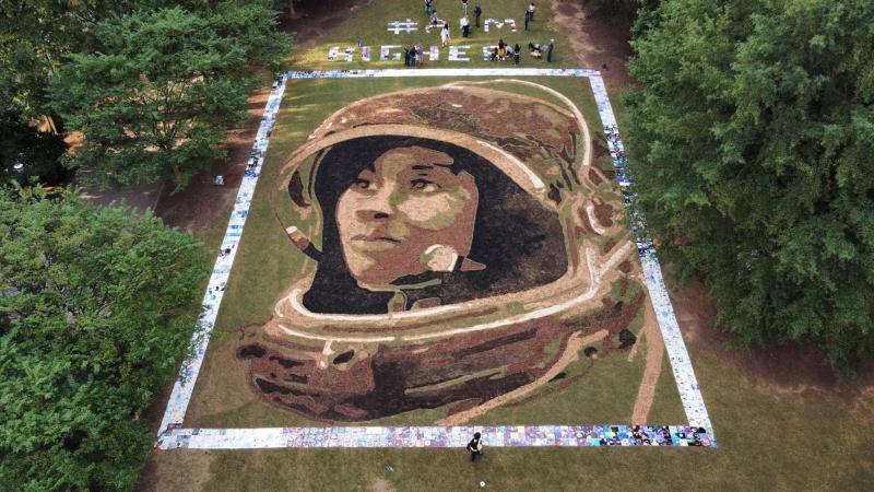 Artist Stan Herd's portrait of NASA astronaut Stephanie Wilson on display in Atlanta is 70 feet by 90 feet. Artist Stan Herd's portrait of NASA astronaut Stephanie Wilson on display in Atlanta is 70 feet by 90 feet.