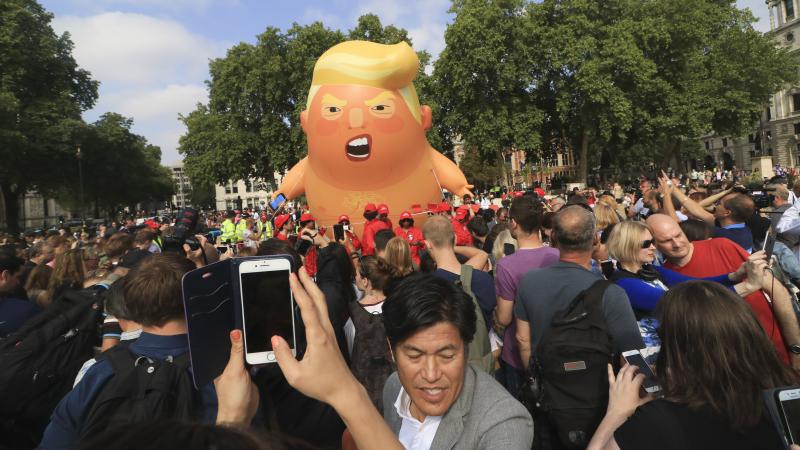 A protest against President Trump in London's Parliament Square includes a giant balloon of "Trump Baby" in a diaper on Friday. It flew high above the statutes of prominent historical figures including Winston Churchill, Mahatma Gandhi and Millicent Fawce A protest against President Trump in London's Parliament Square includes a giant balloon of "Trump Baby" in a diaper on Friday. It flew high above the statutes of prominent historical figures including Winston Churchill, Mahatma Gandhi and Millicent Fawce
