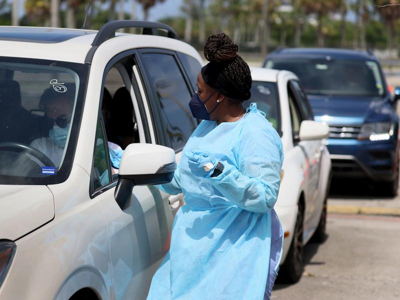 A health care worker at a drive-through site prepares to administer a COVID-19 vaccine on July 26 in Miami. A health care worker at a drive-through site prepares to administer a COVID-19 vaccine on July 26 in Miami.