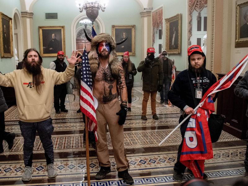 Supporters of President Donald Trump, including Jake Angeli (center), a QAnon supporter known for his painted face and horned hat, standing inside the U.S. Capitol on Jan. 6, 2021. Demonstrators breeched security and entered the Capitol as Congress debate Supporters of President Donald Trump, including Jake Angeli (center), a QAnon supporter known for his painted face and horned hat, standing inside the U.S. Capitol on Jan. 6, 2021. Demonstrators breeched security and entered the Capitol as Congress debate