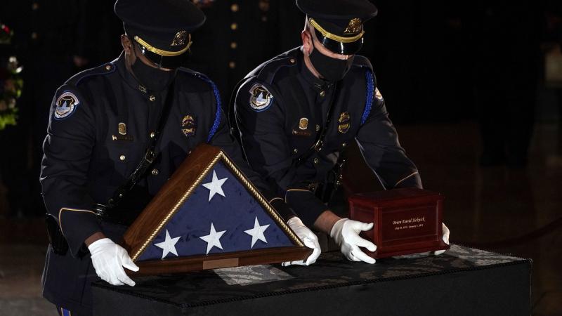 Sicknick's remains are placed next to a U.S. flag on a pedestal in the Capitol Rotunda Tuesday evening. Sicknick's remains are placed next to a U.S. flag on a pedestal in the Capitol Rotunda Tuesday evening.