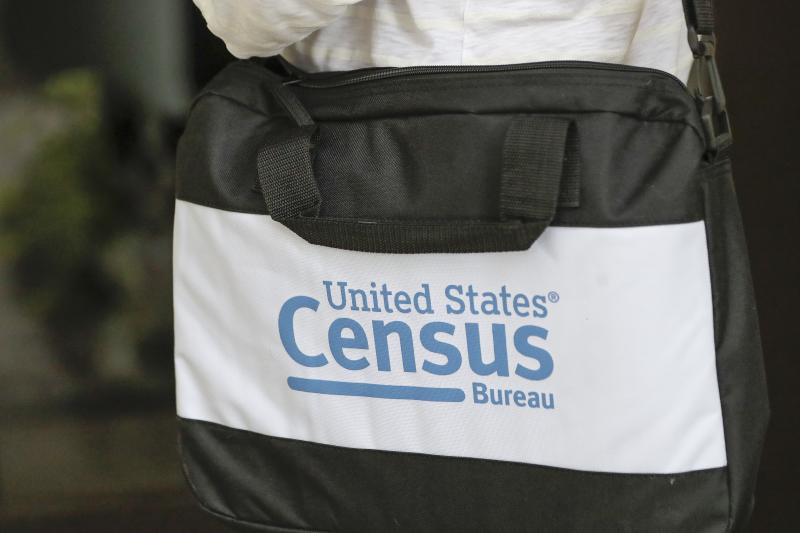 A U.S. Census Bureau worker carries a briefcase while knocking on the door of a home in August in Winter Park, Fla. A U.S. Census Bureau worker carries a briefcase while knocking on the door of a home in August in Winter Park, Fla.