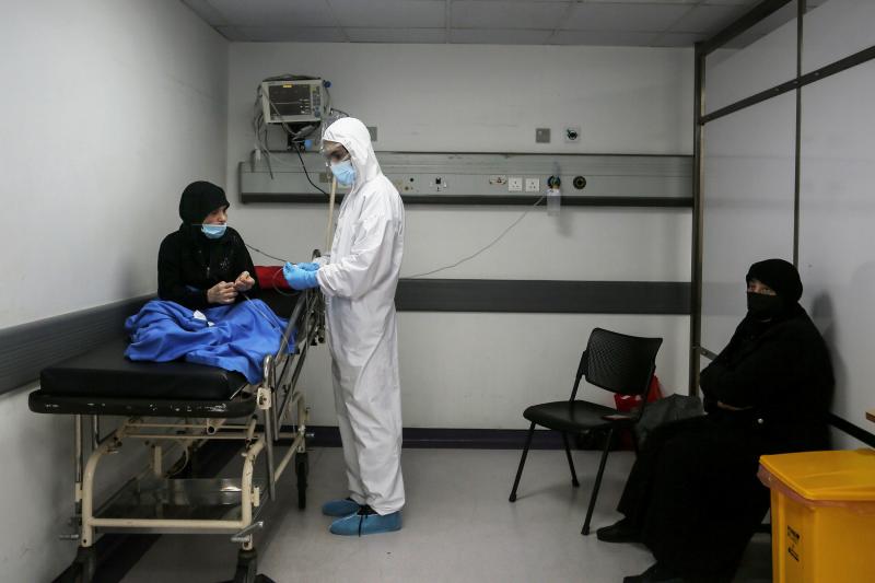 Inside an emergency room at Rafik Hariri Hospital on Nov. 17, a medic wearing full protective gear checks a woman who might have the coronavirus. Beirut hospitals are reaching maximum capacity amid an influx of coronavirus patients. Inside an emergency room at Rafik Hariri Hospital on Nov. 17, a medic wearing full protective gear checks a woman who might have the coronavirus. Beirut hospitals are reaching maximum capacity amid an influx of coronavirus patients.