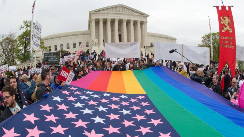 Protesters hold a pro-gay-rights flag outside the US Supreme Court on Saturday, countering the demonstrators who attended the March For Marriage in Washington, D.C. The Supreme Court meets on Tuesday to hear arguments over whether same-sex couples have a Protesters hold a pro-gay-rights flag outside the US Supreme Court on Saturday, countering the demonstrators who attended the March For Marriage in Washington, D.C. The Supreme Court meets on Tuesday to hear arguments over whether same-sex couples have a
