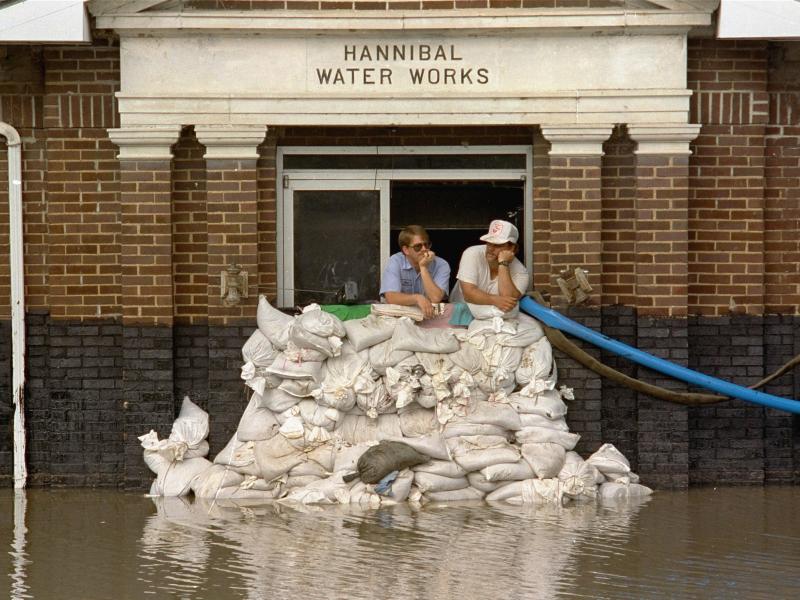 Mike Stone, left, and Andy Sherman in the pumping station for Hannibal, Mo., during a flood in 1993. The city has since constructed a flood wall, and flood managers have built up levees to protect against flooding. But scientists warn those structures are Mike Stone, left, and Andy Sherman in the pumping station for Hannibal, Mo., during a flood in 1993. The city has since constructed a flood wall, and flood managers have built up levees to protect against flooding. But scientists warn those structures are
