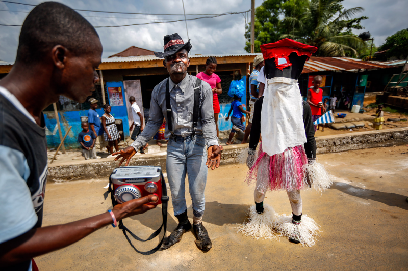 In addition to the dancing devils, there's Old Man Beggar, who also parades around on Christmas. At right is a Liberian version of Santa. In addition to the dancing devils, there's Old Man Beggar, who also parades around on Christmas. At right is a Liberian version of Santa.