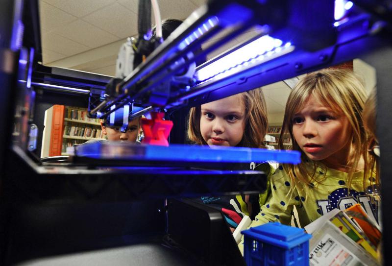 Liam Gaynor (center), 8, and Laura Stark (right), 8, watch as an object is made on a 3-D printer at the Hillsdale (N.J.) Public Library in January. Liam Gaynor (center), 8, and Laura Stark (right), 8, watch as an object is made on a 3-D printer at the Hillsdale (N.J.) Public Library in January.