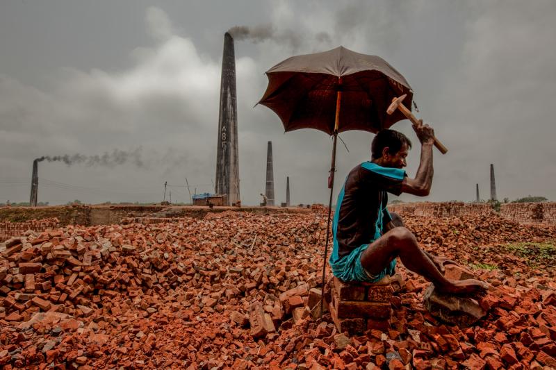 Breaking bricks is one of the lowest-paying jobs in Bangladesh. This photo was shot at a brick kiln in the Dhaka District, home to the capital city of Dhaka. Breaking bricks is one of the lowest-paying jobs in Bangladesh. This photo was shot at a brick kiln in the Dhaka District, home to the capital city of Dhaka.