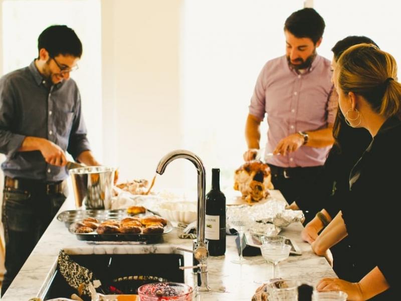 Michael Durand (left), husband of Kitchn Editor-In-Chief Faith Durand, and friend Chris Gardner (right) carve turkey while guests hang out in the Durands' kitchen, dirty dishes and all, at a recent party. Michael Durand (left), husband of Kitchn Editor-In-Chief Faith Durand, and friend Chris Gardner (right) carve turkey while guests hang out in the Durands' kitchen, dirty dishes and all, at a recent party.