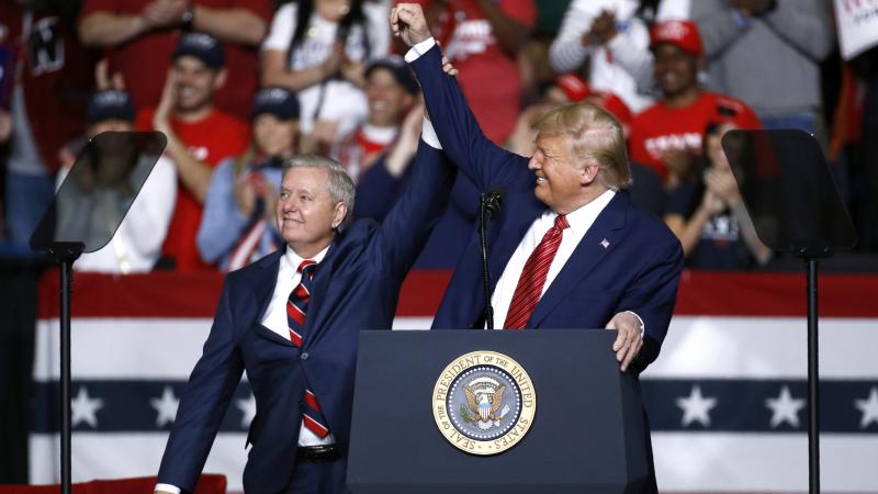 Sen. Lindsey Graham, R-S.C., stands onstage with President Trump during a Feb. 28 campaign rally in North Charleston, S.C. His allegiance to Trump has left some moderate voters feeling snubbed and switching allegiances to Democrat Jaime Harrison. Sen. Lindsey Graham, R-S.C., stands onstage with President Trump during a Feb. 28 campaign rally in North Charleston, S.C. His allegiance to Trump has left some moderate voters feeling snubbed and switching allegiances to Democrat Jaime Harrison.