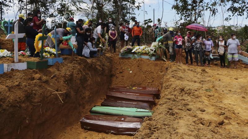 Relatives mourn at the site of a mass burial at the Nossa Senhora Aparecida cemetery, in Manaus, Amazonas state, Brazil, on Tuesday. The cemetery is carrying out burials in common graves due to the large number of deaths from COVID-19 disease, according t Relatives mourn at the site of a mass burial at the Nossa Senhora Aparecida cemetery, in Manaus, Amazonas state, Brazil, on Tuesday. The cemetery is carrying out burials in common graves due to the large number of deaths from COVID-19 disease, according t
