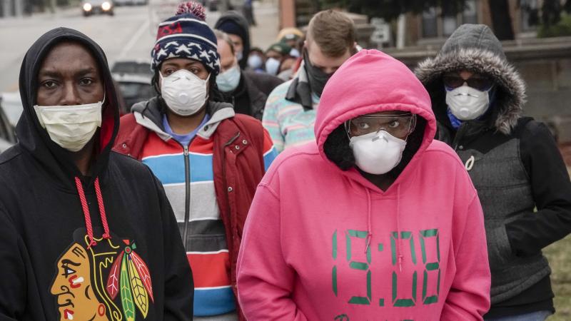 Voters masked to protect from the coronavirus line up at Riverside High School in Milwaukee. Voting went forward in the state, despite the ongoing pandemic. Voters masked to protect from the coronavirus line up at Riverside High School in Milwaukee. Voting went forward in the state, despite the ongoing pandemic.