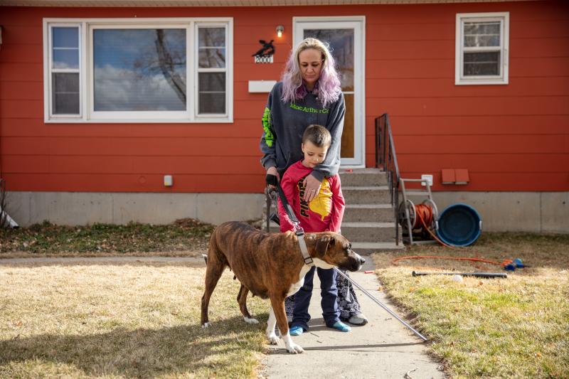 Barbara Gaught stands outside the home she's now renting in Billings, Mont., with her 5-year-old son, Blazen, and their dog, Arie. Gaught and her family were evicted from the mobile home they had owned outright and lived in for 16 years because they fell Barbara Gaught stands outside the home she's now renting in Billings, Mont., with her 5-year-old son, Blazen, and their dog, Arie. Gaught and her family were evicted from the mobile home they had owned outright and lived in for 16 years because they fell