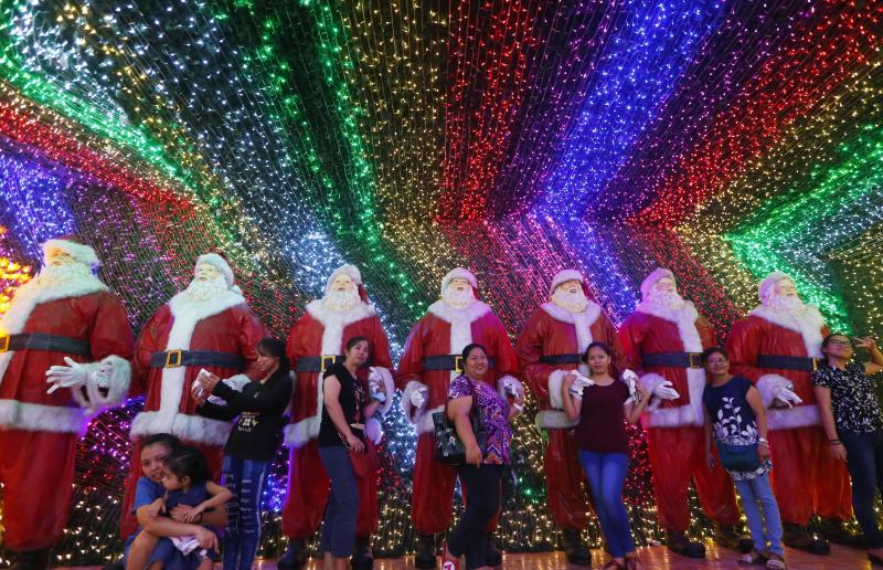 Filipinos pose for souvenir shots at the "Christmas House" owned by businessman Alexander Cruz in suburban Cainta, Rizal province, Philippines, on Dec. 12, 2017. The whole house, decorated with hundreds of thousands of LED lights, has attracted local and Filipinos pose for souvenir shots at the "Christmas House" owned by businessman Alexander Cruz in suburban Cainta, Rizal province, Philippines, on Dec. 12, 2017. The whole house, decorated with hundreds of thousands of LED lights, has attracted local and