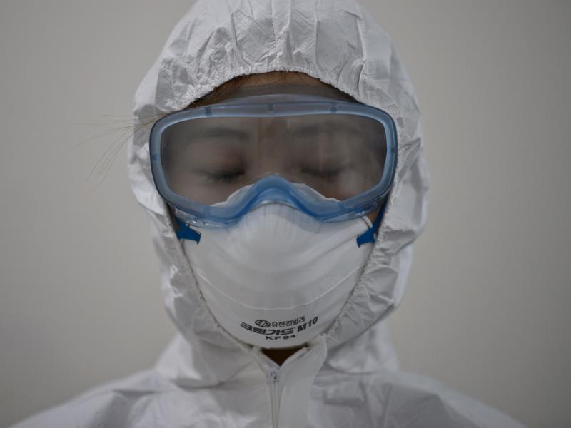 A medical staff member wearing a protective suit waits to enter an isolation ward for patients with Middle East respiratory syndrome, or MERS, in South Korea. A medical staff member wearing a protective suit waits to enter an isolation ward for patients with Middle East respiratory syndrome, or MERS, in South Korea.