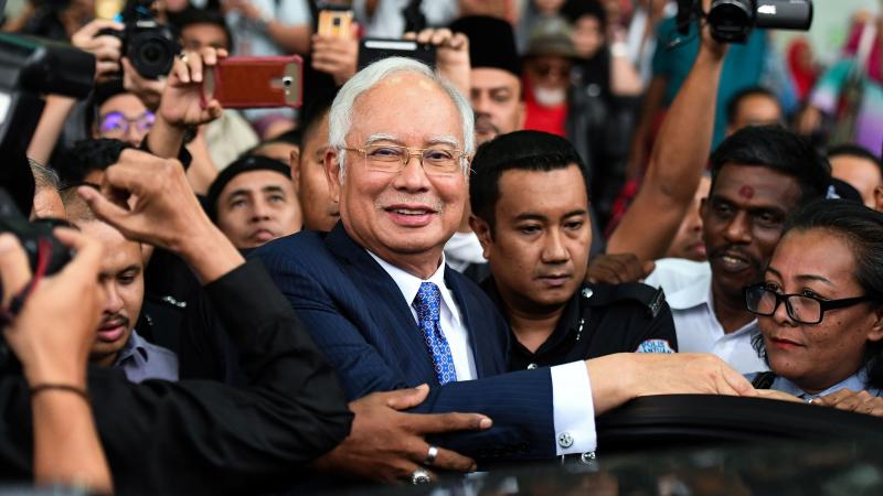 Najib Razak, Malaysia's former prime minister, leaves court in Kuala Lumpur on Wednesday — the first day in his trial over charges that he used a slush fund to put millions of dollars into his own accounts. Najib Razak, Malaysia's former prime minister, leaves court in Kuala Lumpur on Wednesday — the first day in his trial over charges that he used a slush fund to put millions of dollars into his own accounts.
