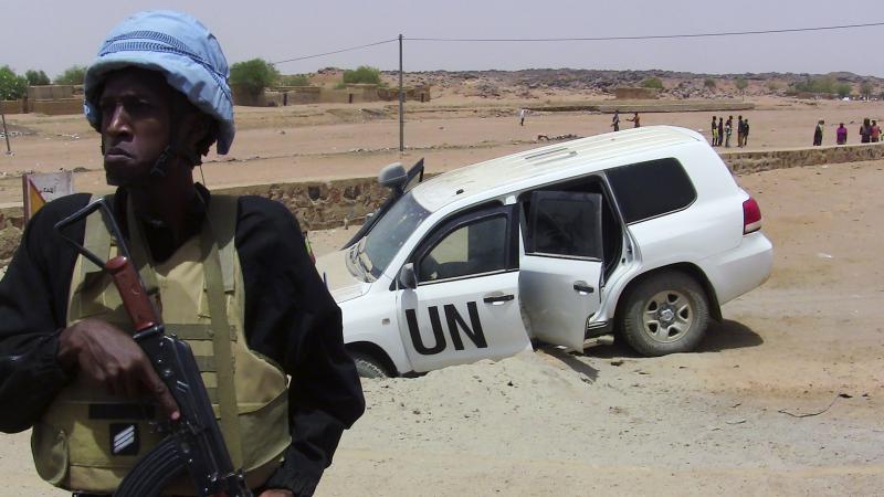 A soldier of the United Nations mission to Mali stands guard near a UN vehicle after it drove over an explosive device near Kidal, northern Mali, on July 14. A soldier of the United Nations mission to Mali stands guard near a UN vehicle after it drove over an explosive device near Kidal, northern Mali, on July 14.
