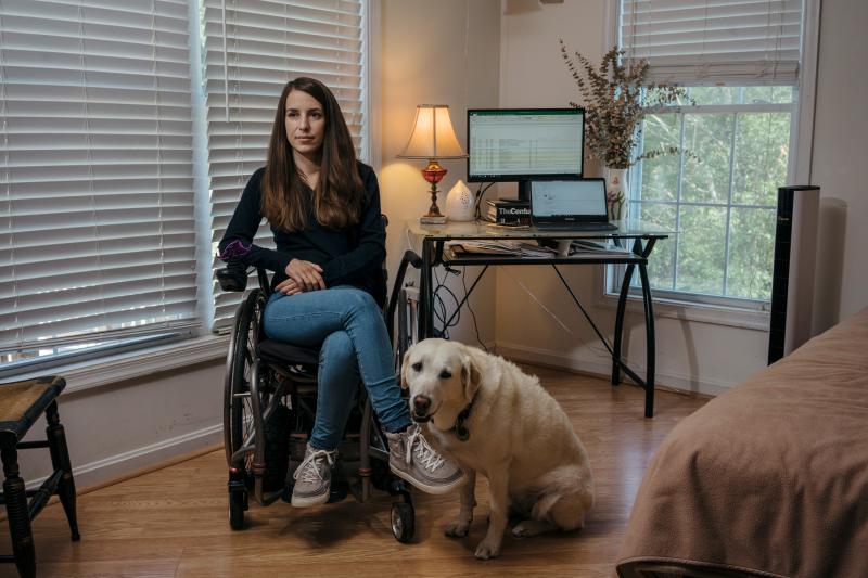 Izzie with her service dog, Zandra. Spinergy welcomed Zandra, who is able to retrieve things when Izzie drops them. Izzie with her service dog, Zandra. Spinergy welcomed Zandra, who is able to retrieve things when Izzie drops them.