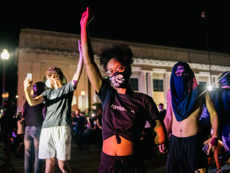 Protesters raise their fist in the air in front of law enforcement last month in Kenosha, Wis., after the police shooting of Jacob Blake. Protesters raise their fist in the air in front of law enforcement last month in Kenosha, Wis., after the police shooting of Jacob Blake.