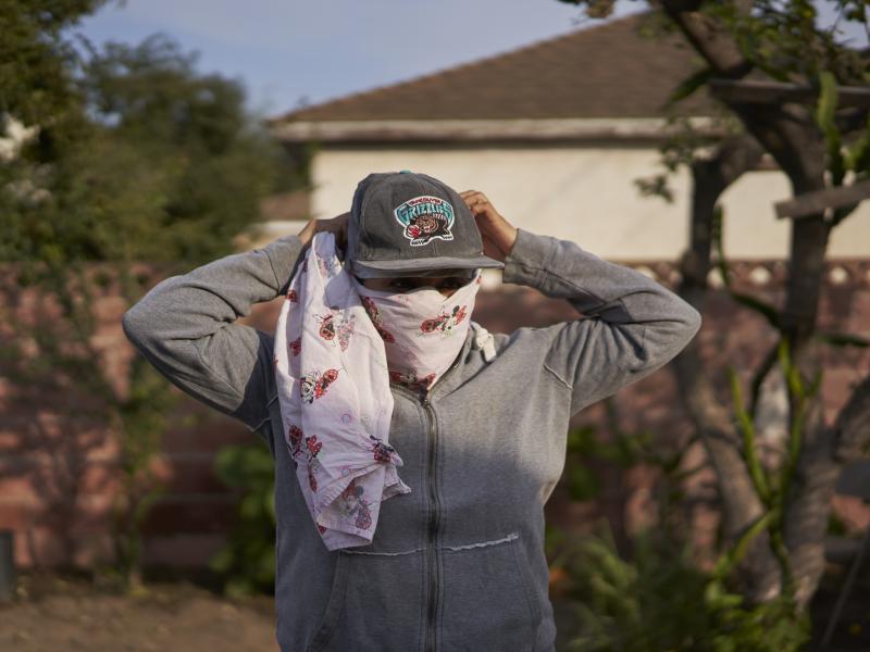 Gabriela, 32, a strawberry picker from Oaxaca, Mexico, who lives in Oxnard, Calif., had to wear a bandanna to cover her nose and mouth to avoid inhaling smoke from a wildfire while working in the fields. Gabriela, 32, a strawberry picker from Oaxaca, Mexico, who lives in Oxnard, Calif., had to wear a bandanna to cover her nose and mouth to avoid inhaling smoke from a wildfire while working in the fields.