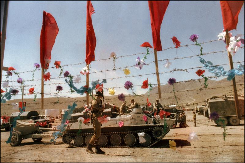 Artificial flowers decorate barbed wire fence as Soviet army troops stop in Kabul, Afghanistan, in May 1988. The Soviet Union invaded Afghanistan in December 1979 to shore up the pro-Soviet regime in Kabul. Artificial flowers decorate barbed wire fence as Soviet army troops stop in Kabul, Afghanistan, in May 1988. The Soviet Union invaded Afghanistan in December 1979 to shore up the pro-Soviet regime in Kabul.