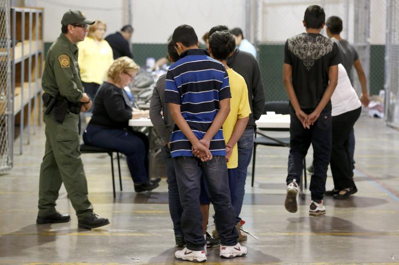 Boys wait in line to make a phone call at the U.S. Customs and Border Protection Nogales Placement Center in Arizona in June. Many of the minors who arrived from Central America last year are now awaiting court hearings to determine if they can stay in th Boys wait in line to make a phone call at the U.S. Customs and Border Protection Nogales Placement Center in Arizona in June. Many of the minors who arrived from Central America last year are now awaiting court hearings to determine if they can stay in th