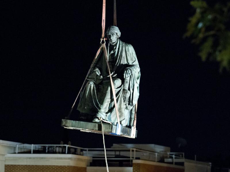 Workers use a crane to lift the monument dedicated to former Chief Justice of the United States Roger Taney in Annapolis, Md., early Friday. The State House Trust voted Wednesday to remove the statue from its grounds. Workers use a crane to lift the monument dedicated to former Chief Justice of the United States Roger Taney in Annapolis, Md., early Friday. The State House Trust voted Wednesday to remove the statue from its grounds.