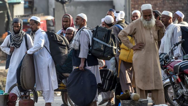 Tablighi Jamaat members prepare to leave after a mass religious gathering outside Lahore on March 13. Tablighi Jamaat members prepare to leave after a mass religious gathering outside Lahore on March 13.
