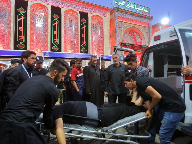 People evacuate an injured man after a walkway collapsed and set off a stampede as thousands of Shiite Muslims marked one of the most solemn holy days of the year in the holy city of Karbala, Iraq, on Tuesday. People evacuate an injured man after a walkway collapsed and set off a stampede as thousands of Shiite Muslims marked one of the most solemn holy days of the year in the holy city of Karbala, Iraq, on Tuesday.