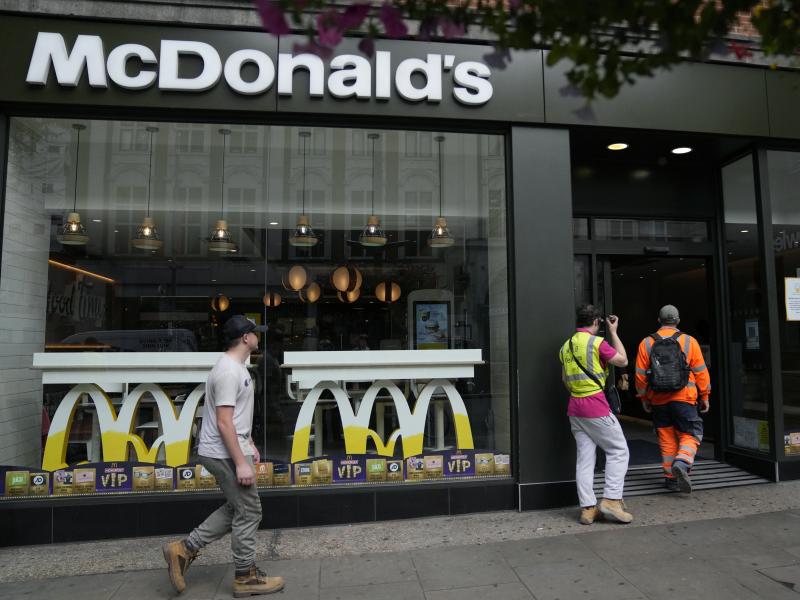 Customers walks into a McDonald's restaurant, in London on Aug. 24. McDonald's says it has pulled milkshakes from the menu in all 1,250 of its British restaurants because of supply problems stemming from a shortage of truck drivers. Customers walks into a McDonald's restaurant, in London on Aug. 24. McDonald's says it has pulled milkshakes from the menu in all 1,250 of its British restaurants because of supply problems stemming from a shortage of truck drivers.