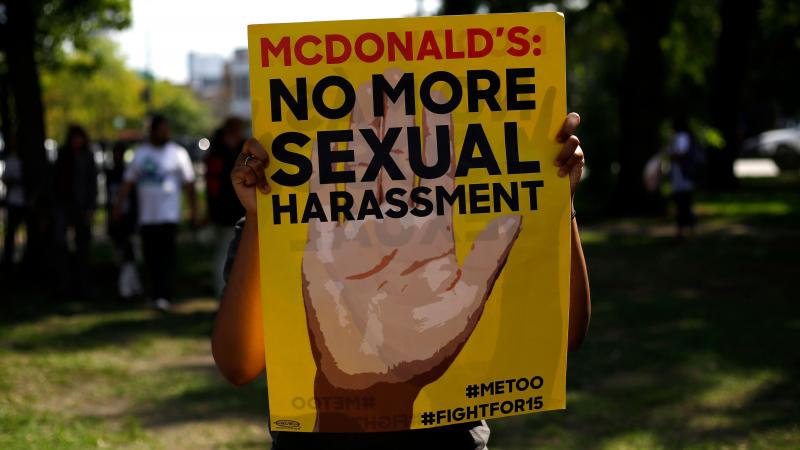 A McDonald's employee holds a sign during a 2018 protest against sexual harassment in the workplace in Chicago. A McDonald's employee holds a sign during a 2018 protest against sexual harassment in the workplace in Chicago.