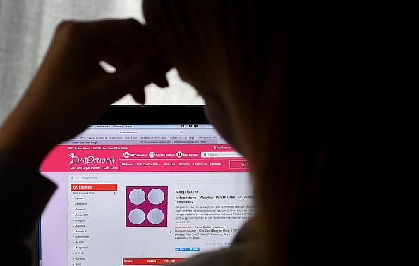 In this photo illustration, a person looks at an Abortion Pill (RU-486) for unintended pregnancy from Mifepristone displayed on a computer on May 8 in Arlington, Va. In this photo illustration, a person looks at an Abortion Pill (RU-486) for unintended pregnancy from Mifepristone displayed on a computer on May 8 in Arlington, Va.