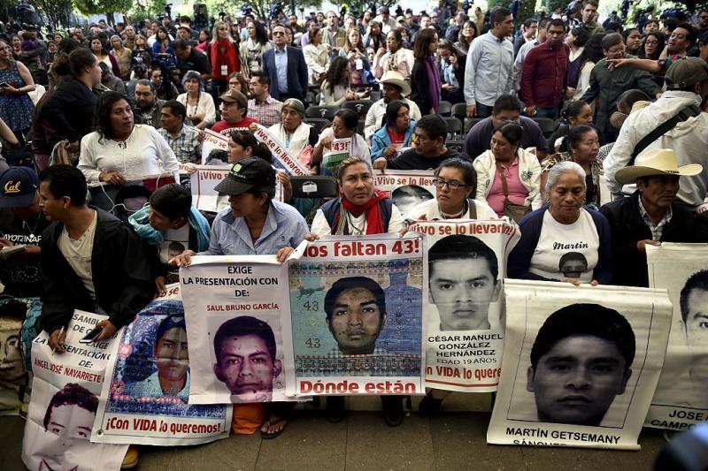 Parents and other relatives of the 43 missing students from the Ayotzinapa's teachers school attend the reading of the final report from the Interdisciplinary Group of Independent Experts (GIEI) in Mexico City on Sunday. Parents and other relatives of the 43 missing students from the Ayotzinapa's teachers school attend the reading of the final report from the Interdisciplinary Group of Independent Experts (GIEI) in Mexico City on Sunday.