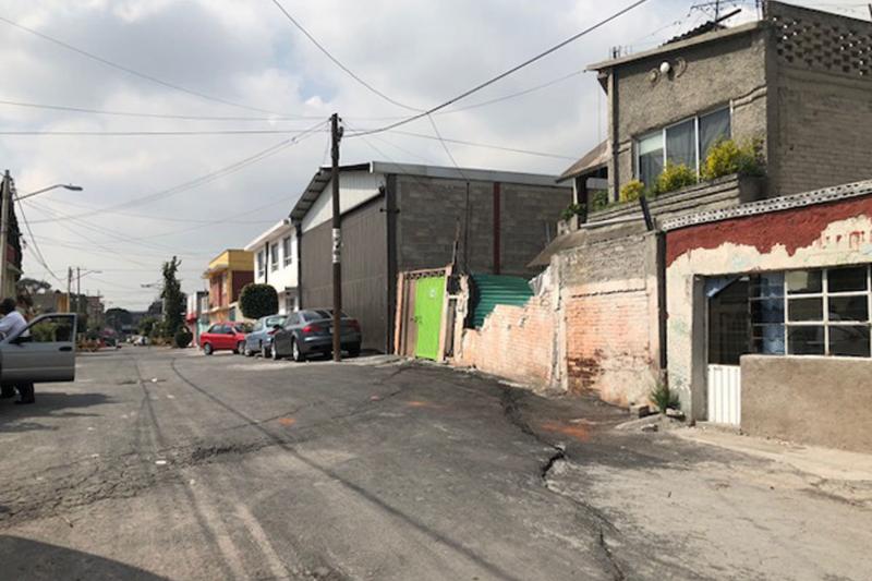A large crack cuts through this Mexico City street. Half of the street is lower than the other half, one of many signs this metropolis is sinking. A large crack cuts through this Mexico City street. Half of the street is lower than the other half, one of many signs this metropolis is sinking.