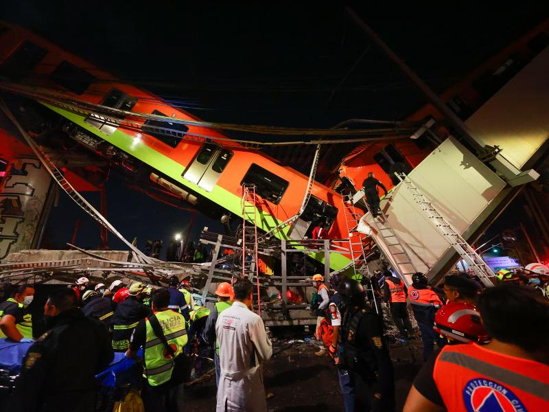 Emergency personnel search for survivors after a raised subway track collapsed Monday night in Mexico City. Emergency personnel search for survivors after a raised subway track collapsed Monday night in Mexico City.