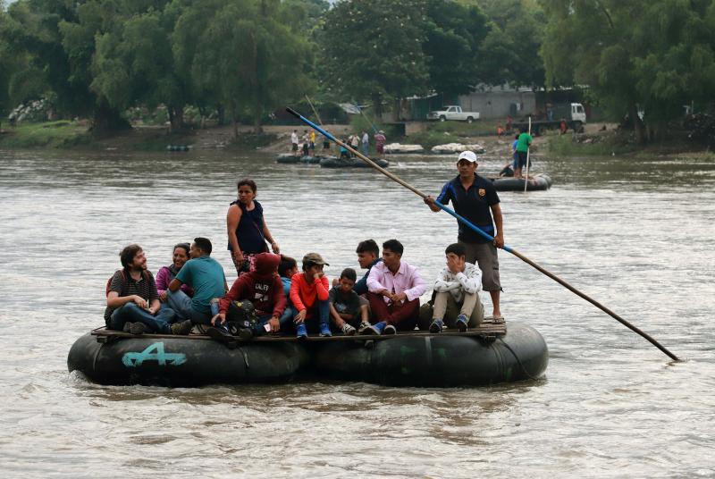 Central American migrants and a Spanish journalist ride a makeshift raft across the Suchiate River from Tecún Umán in Guatemala to Ciudad Hidalgo in Chiapas state, Mexico, on June 11. Central American migrants and a Spanish journalist ride a makeshift raft across the Suchiate River from Tecún Umán in Guatemala to Ciudad Hidalgo in Chiapas state, Mexico, on June 11.