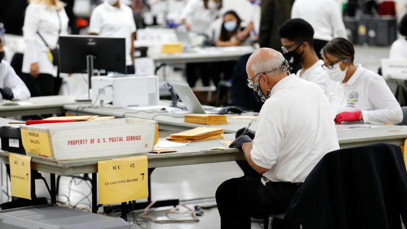 Election workers count absentee ballots earlier this month in Detroit, the county seat of Wayne County, Mich. Election workers count absentee ballots earlier this month in Detroit, the county seat of Wayne County, Mich.
