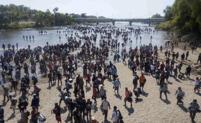 Central American migrants cross the Suchiate River by foot from Guatemala (left) to Ciudad Hidalgo, Mexico, on Monday. Central American migrants cross the Suchiate River by foot from Guatemala (left) to Ciudad Hidalgo, Mexico, on Monday.
