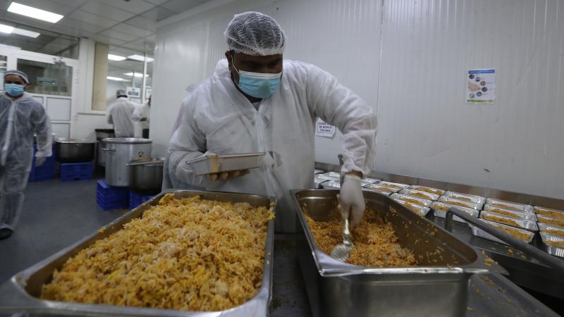 Qatar charity workers prepare food parcels for migrant laborers living under quarantine on April 16 amid the coronavirus pandemic in Doha. A restaurant better known for fine dining has lent its facilities to Qatar Charity to feed migrant workers, of whom Qatar charity workers prepare food parcels for migrant laborers living under quarantine on April 16 amid the coronavirus pandemic in Doha. A restaurant better known for fine dining has lent its facilities to Qatar Charity to feed migrant workers, of whom