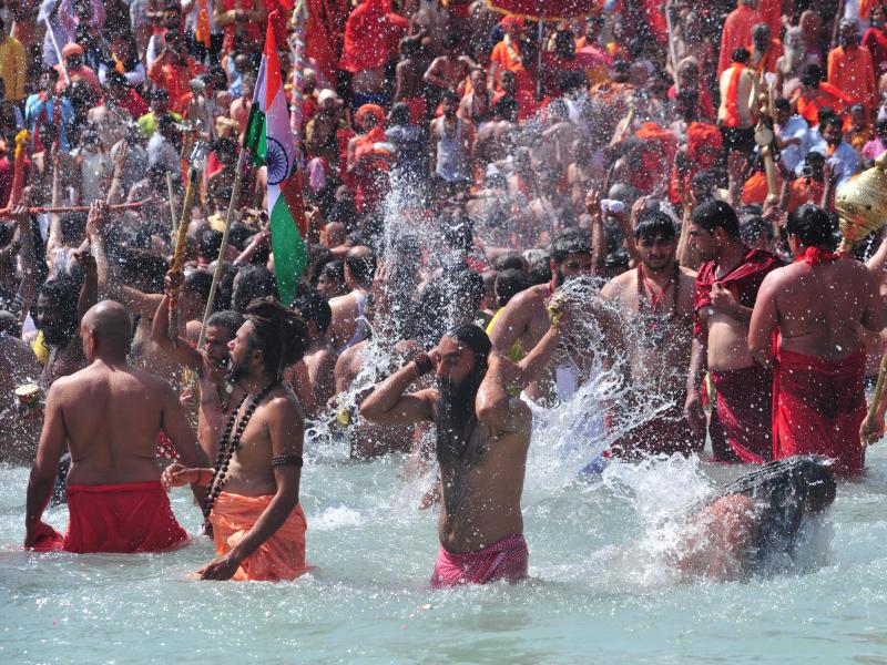 Men take a holy dip in the Ganges River on the occasion of first royal bath of Shivratri festival during Maha Kumbh Festival in Haridwar, India. Men take a holy dip in the Ganges River on the occasion of first royal bath of Shivratri festival during Maha Kumbh Festival in Haridwar, India.