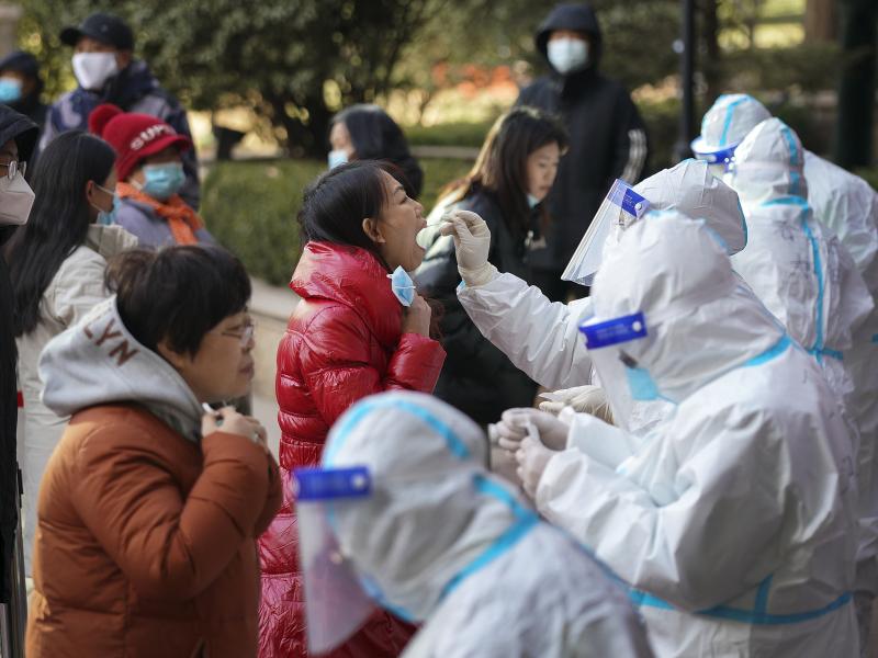 In this photo released by Xinhua News Agency, medical workers take swabs from residents in Shijiazhuang in north China's Hebei province on Jan. 6. Authorities have announced new restrictions to contain the coronavirus. In this photo released by Xinhua News Agency, medical workers take swabs from residents in Shijiazhuang in north China's Hebei province on Jan. 6. Authorities have announced new restrictions to contain the coronavirus.