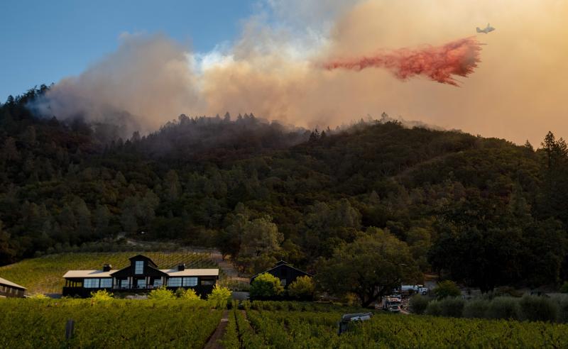 A California Department of Forestry and Fire Protection airplane drops fire retardant along a burning hill during the Glass Fire in Calistoga, Calif., in September. California is one of two states to require wildfire risk be disclosed to new homebuyers. A California Department of Forestry and Fire Protection airplane drops fire retardant along a burning hill during the Glass Fire in Calistoga, Calif., in September. California is one of two states to require wildfire risk be disclosed to new homebuyers.