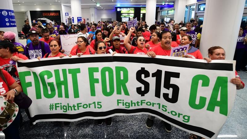 Airport employees, Uber and Lyft drivers, and other workers protest for a $15 minimum wage at Los Angeles International Airport in October. Increases in minimum wages contributed to bigger pay gains for lower-income workers. Airport employees, Uber and Lyft drivers, and other workers protest for a $15 minimum wage at Los Angeles International Airport in October. Increases in minimum wages contributed to bigger pay gains for lower-income workers.