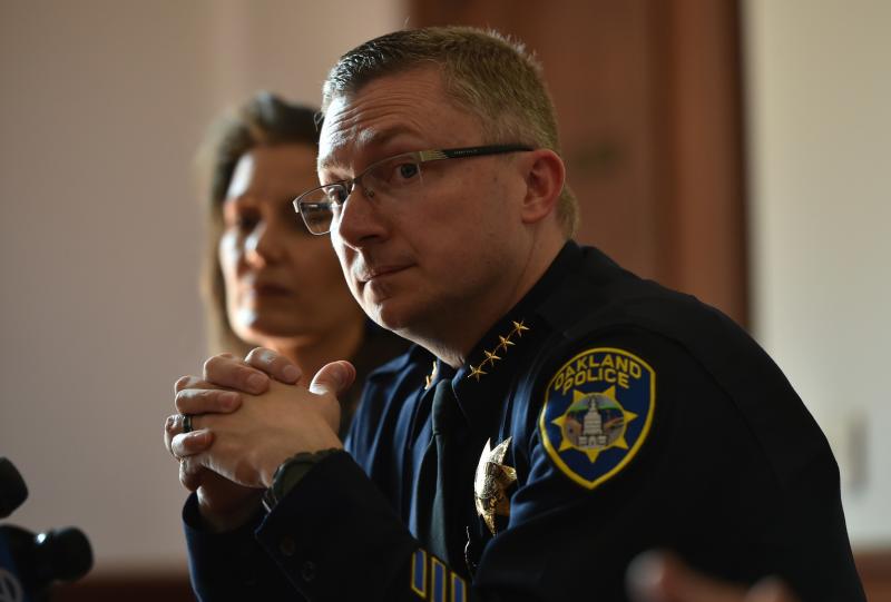Oakland Police Chief Sean Whent, with Mayor Libby Schaaf behind him, listens to questions from the media on May 2, 2015, after May Day protests in Oakland, Calif. Whent has since resigned as police chief — as did two interim chiefs after him, over the Oakland Police Chief Sean Whent, with Mayor Libby Schaaf behind him, listens to questions from the media on May 2, 2015, after May Day protests in Oakland, Calif. Whent has since resigned as police chief — as did two interim chiefs after him, over the