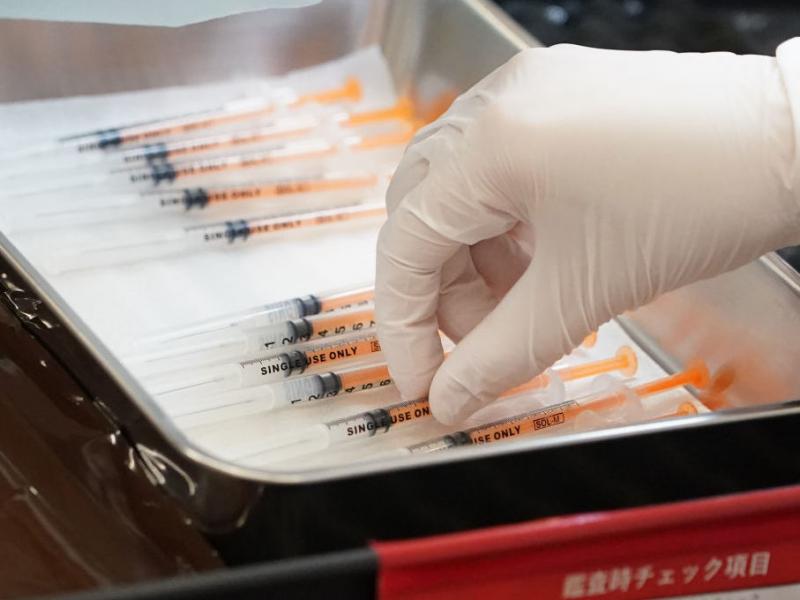A health care worker prepares the current COVID vaccine booster shots from Moderna in February. The company says a bivalent vaccine that combines the original strain with the omicron strain is the lead candidate for a fall vaccination campaign. A health care worker prepares the current COVID vaccine booster shots from Moderna in February. The company says a bivalent vaccine that combines the original strain with the omicron strain is the lead candidate for a fall vaccination campaign.