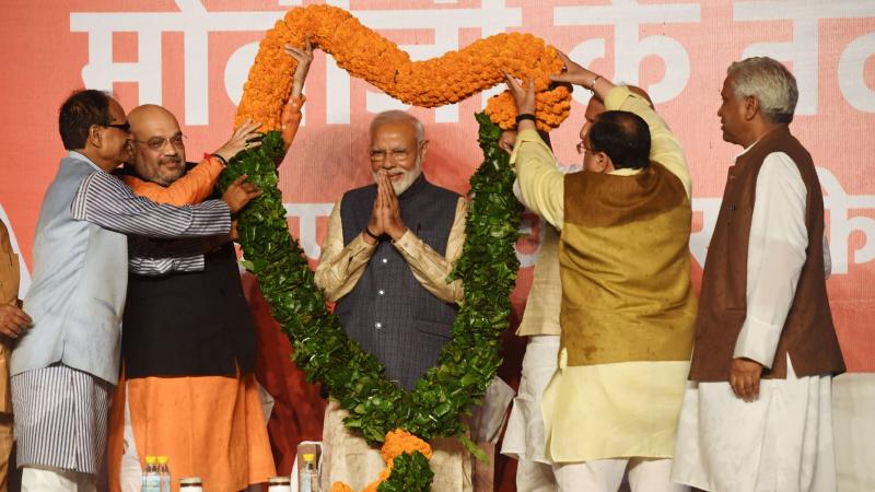 Indian Prime Minister Narendra Modi is adorned with a garland of flowers by members of his political party at their headquarters in New Delhi on Thursday, following a victory in the country's national elections. Indian Prime Minister Narendra Modi is adorned with a garland of flowers by members of his political party at their headquarters in New Delhi on Thursday, following a victory in the country's national elections.