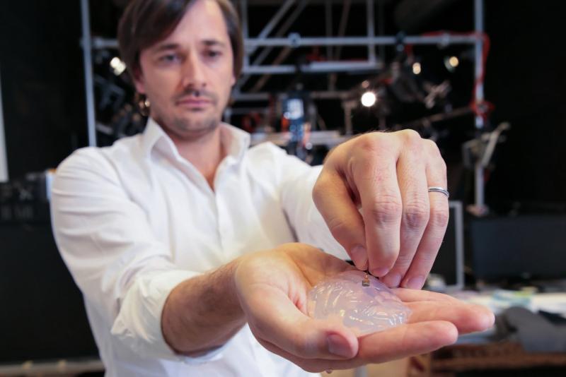 Gregoire Courtine, a neurologist at the Swiss Federal Institute of Technology, holds a silicone model of a primate's brain with an electrode array. The goal is to pick up signals from the brain and transmit them to the legs. Gregoire Courtine, a neurologist at the Swiss Federal Institute of Technology, holds a silicone model of a primate's brain with an electrode array. The goal is to pick up signals from the brain and transmit them to the legs.