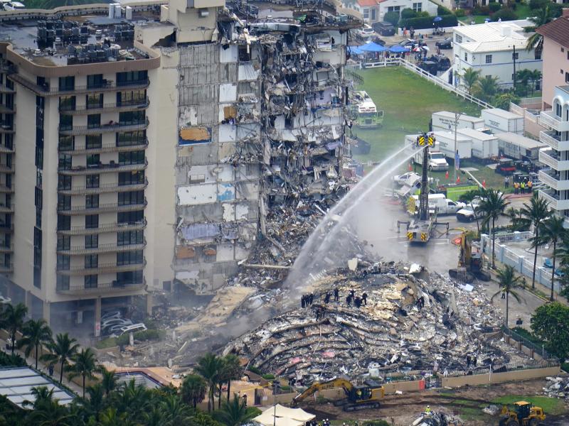In this June 25, 2021, file photo, rescue personnel work at the remains of the Champlain Towers South condo building in Surfside, Fla. In this June 25, 2021, file photo, rescue personnel work at the remains of the Champlain Towers South condo building in Surfside, Fla.