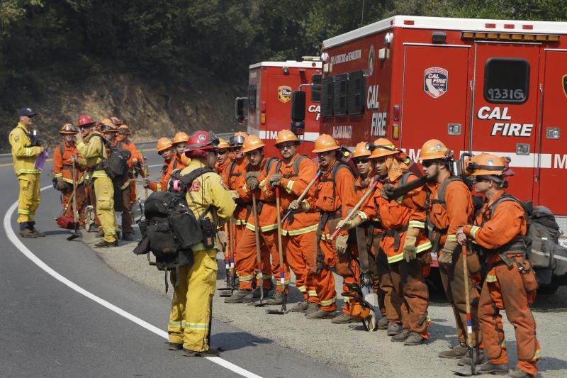 Prisoners from the McCain inmate crew from San Diego prepare to clear brush from a road on Wednesday in Calistoga. Prisoners from the McCain inmate crew from San Diego prepare to clear brush from a road on Wednesday in Calistoga.